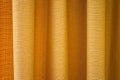 Fabric yellow curtains with folds . Abstract background, curtain, drapes gold fabric. Royalty Free Stock Photo