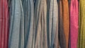 Fabrics of different colors and textures hang vertically. Royalty Free Stock Photo