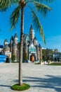 Fabulous castle in a amusement park with palm under sunlight