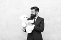 Fabulous gift for little ones. Bearded man hold teddy bear. Businessman with toy gift blue background. Happy boxing day
