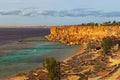 Fabulous landscape view of the bay in the Red Sea with clear water and corals. Nice beach with many umbrellas and sand