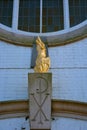 Golden Fenix statue and pax christi symbol, sign