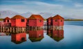 Fabulous morning view of red wooden fishing dock on popular tourist attraction Patocut Laguna.