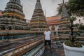 Fabulous, mystical, Buddhist Asian temple. Tourist on vacation. A man walks around the ancient pagodas. Wat Pho in