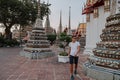 Fabulous, mystical, Buddhist Asian temple. Tourist on vacation. A man walks around the ancient pagodas. Wat Pho in