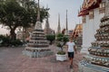 Fabulous, mystical, Buddhist Asian temple. Tourist on vacation. A man walks around the ancient pagodas. Wat Pho in