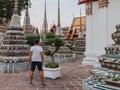 Fabulous, mystical, Buddhist Asian temple. Tourist on vacation. A man walks around the ancient pagodas. Wat Pho in