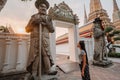 Fabulous, mystical, Buddhist Asian temple. The woman is impressed by the beauty of the statues. The girl looks at the