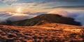 Fabulous sunset high in the mountains above the clouds. Aerial view of dramatic mountain landscape at dusk with fog and soft light