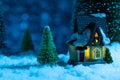 fabulous winter house in the forest at night, the moon is shining, it is snowing. New year greeting card Royalty Free Stock Photo