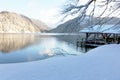 Fabulous winter view of mountain lake. Boat storage house covered with snow. White clean snowy shore and distant mounts Royalty Free Stock Photo