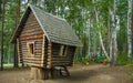 Fabulous wooden hut stands on stumps in the forest