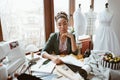 Fabulous young tailor in design studio. Young woman near sewing machine Royalty Free Stock Photo