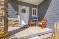 Facacde of a home with furniture on the welcoming sunlit porch