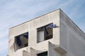 Facade of an abandoned building with collapsed window and broken blue curtains Royalty Free Stock Photo