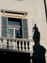 Facade of an ancient building with shadow and reflection of a statue of a warrior knight with horse