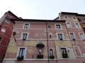 Facade of an ancient damaged building in the historic center of Rome in Italy.