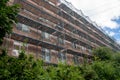 facade of an apartment building in scaffolding. Renovation of the facade