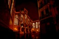 Facade of the Art Nouveau market `Mercat Central` illuminated in the night with wet street in Valencia, Spain