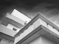 The facade of avant-garde minimalist house with balconies in black and white. Detail of exterior urban architecture