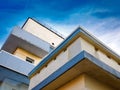 The facade of avant-garde minimalist house with balconies. Detail of exterior urban architecture