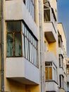 The facade of avant-garde minimalist house with balconies. Detail of exterior urban architecture.