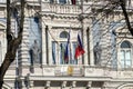 Facade beautiful building of The French Embassy in Riga with two flags, flag of France and EU flag waving on the wind