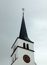 Black pitched roof, bell and clock of Saint William`s church in Strasbourg, France