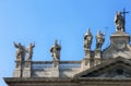 Facade of beautiful old medieval Italian Catholic Cathedral in classical style with marble statues on cruse in Rome Royalty Free Stock Photo