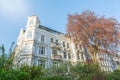 Facade of beautiful white old apartment building in the afternoon sun Royalty Free Stock Photo