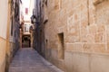 Facade of beige Mediterranean Spanish houses against a clear blue sky