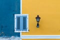 Facade in blue and yellow with windows and street light Royalty Free Stock Photo