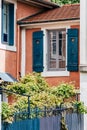 Facade of a brick-colored street house with blue shutters Royalty Free Stock Photo