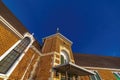 Facade of a brick wall church in Provo Utah with pitched roof and arched windows Royalty Free Stock Photo