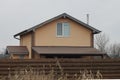 Facade of a brown private house with one window under a tiled roof Royalty Free Stock Photo