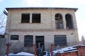 Facade of a brown private unfinished house of brown brick with empty windows and doors Royalty Free Stock Photo