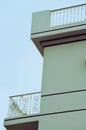 building, Balcony of a red yellow building with blue shutters and various vases