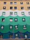 Facade of a building with different colored floors to Rome in Italy.