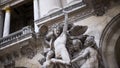 The facade of the building with different decorative architectural elements. Action. Detail of sculpture with angels Royalty Free Stock Photo