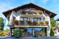 The facade of the building with flowers on the balconies and painted paintings on the walls Royalty Free Stock Photo