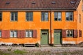 Facade of building with old window frames and wooden doors on old street of Denmark. Historical colorful house