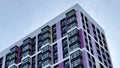 The facade of the building in purple,geometric patterns from windows and balconies, the colored wall of a modern multi Royalty Free Stock Photo