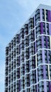 The facade of the building in purple,geometric patterns from windows and balconies, the colored wall of a modern multi Royalty Free Stock Photo