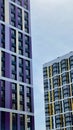 The facade of the building in purple,geometric patterns from windows and balconies, the colored wall of a modern multi Royalty Free Stock Photo