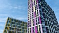 The facade of the building in purple,geometric patterns from windows and balconies, the colored wall of a modern multi Royalty Free Stock Photo