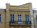 Facade building with three french windows and balcony Royalty Free Stock Photo