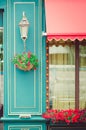 The facade of the cafe, decorated with fresh flowers. Fragment of the building.