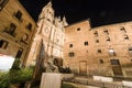 Facade of Casa de las Conchas in Salamanca at night, Spain, covered in scalloped shells, and Salamanca University at illuminated