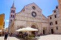 Facade of the Cathedral of St. Anastasia with the bell tower at the background, in Zadar, Croatia, with a bar terrace with Royalty Free Stock Photo