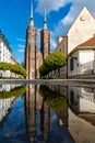 Facade of cathedral of St. John the Baptist reflected in puddle Royalty Free Stock Photo